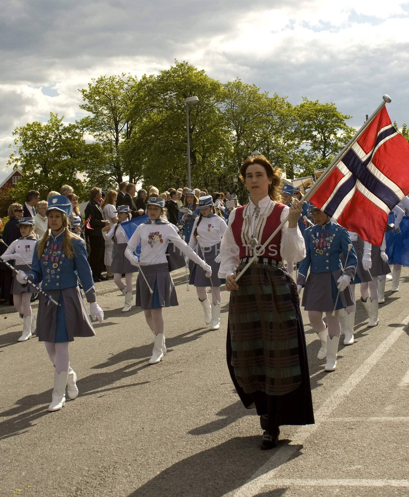 Parade on the Norwegian independence day, the 17th of May. The flag carrier is wearing a national costume from the Kristiansund region. 