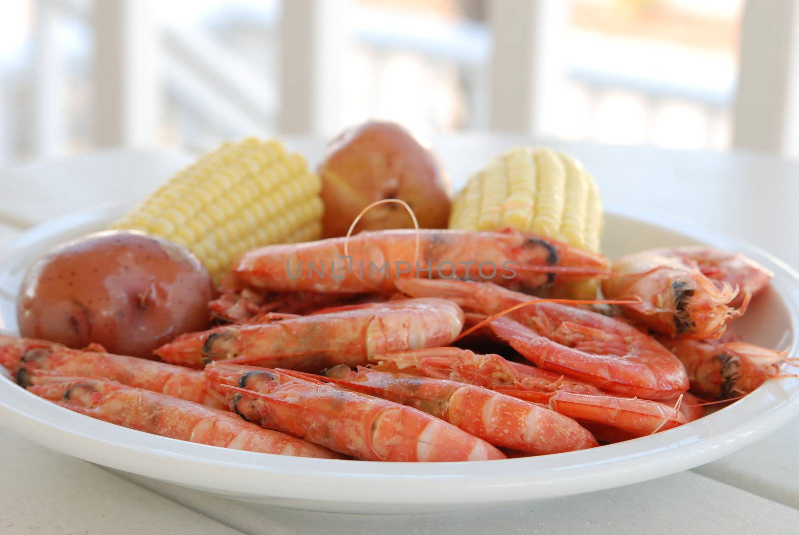 Royal reds shrimp with corn on plate.