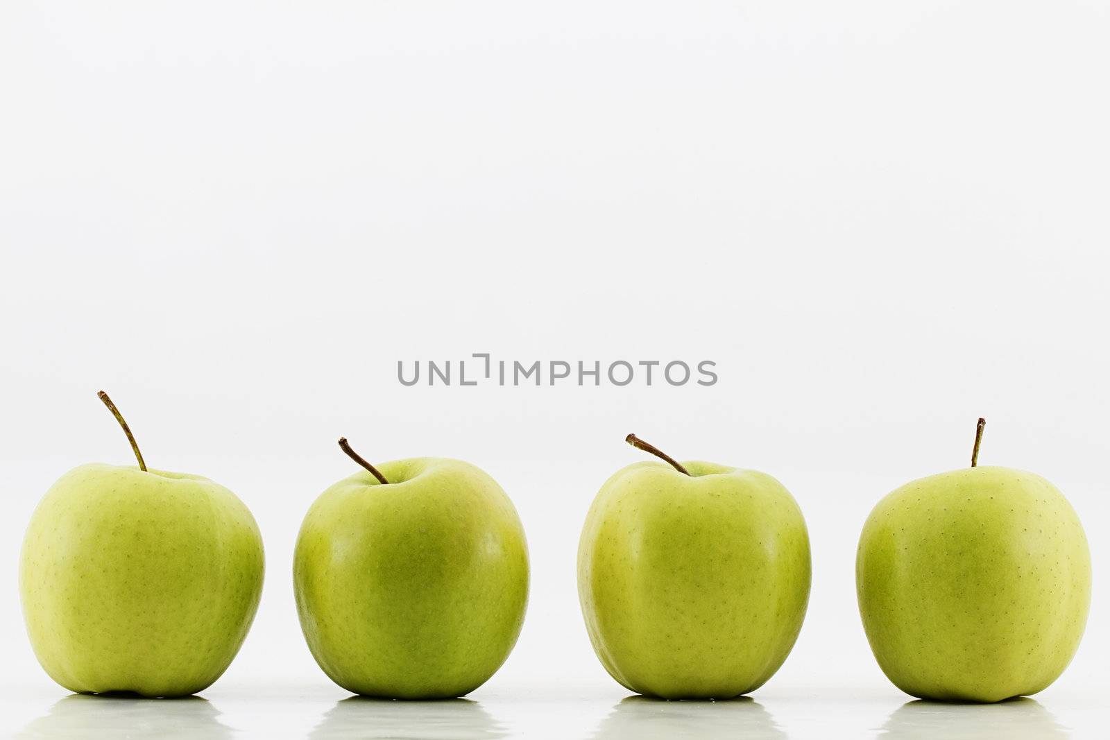 four green apples on white background