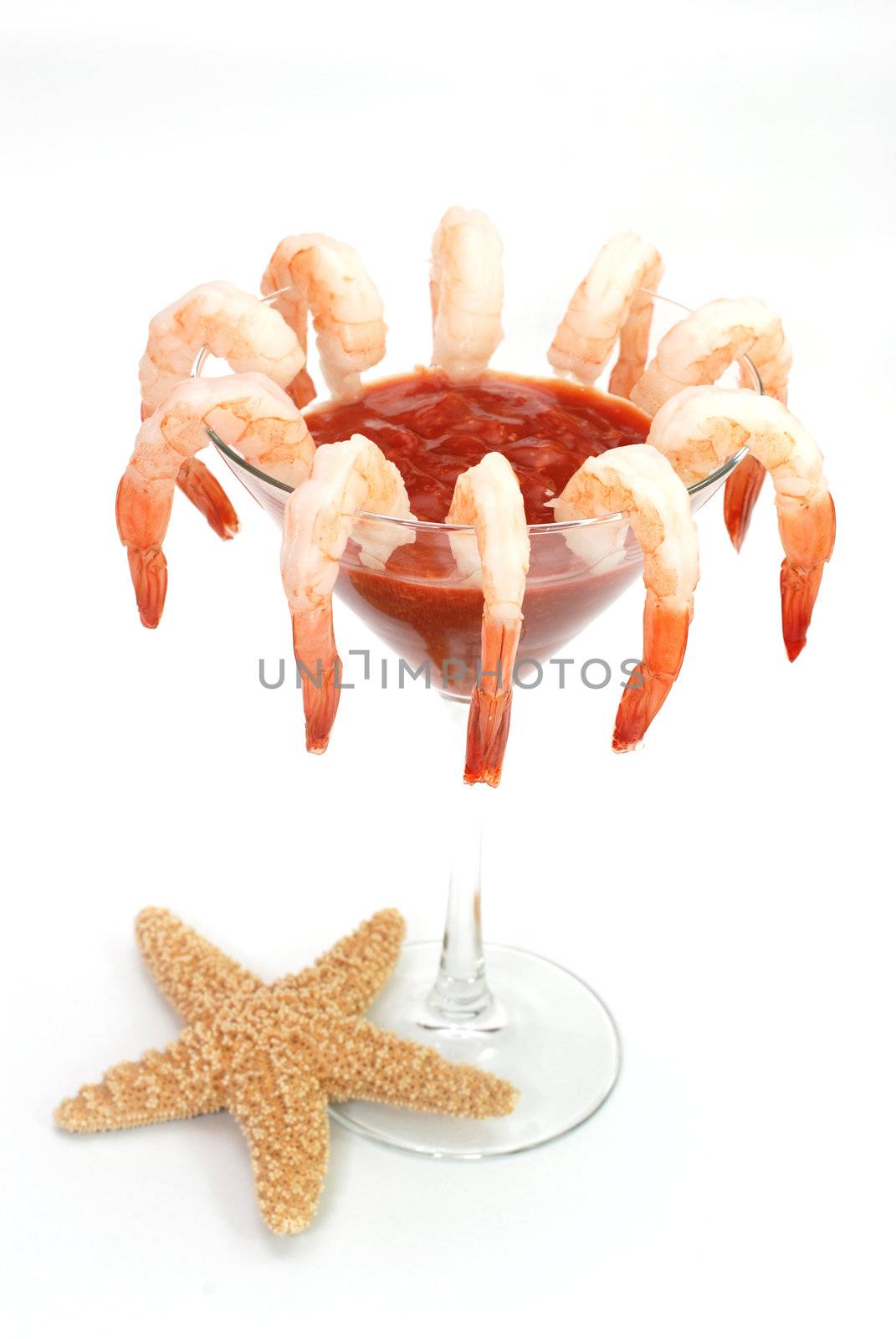 Shrimp cocktail in martini glass with starfish.