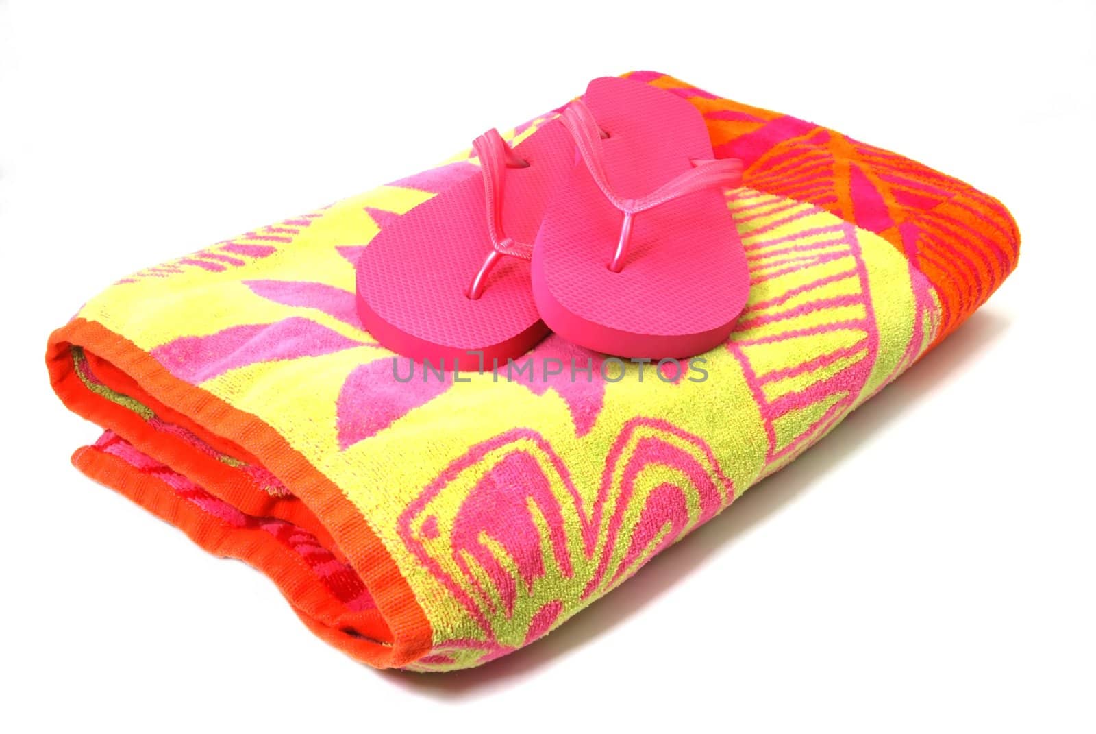 Beach blanket with flip flops isolated on white background with clipping path.