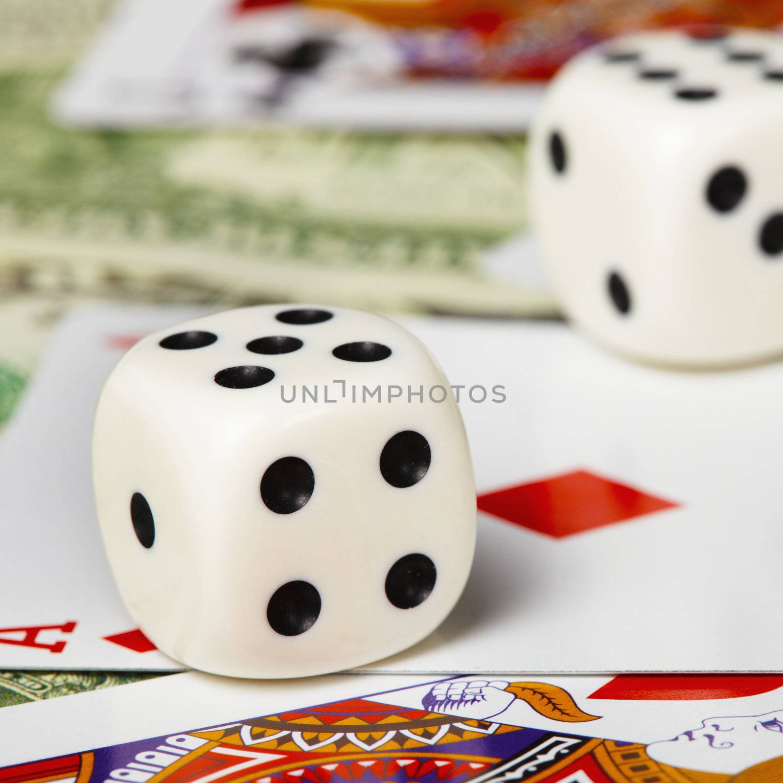 Dice against the cards and money close-up