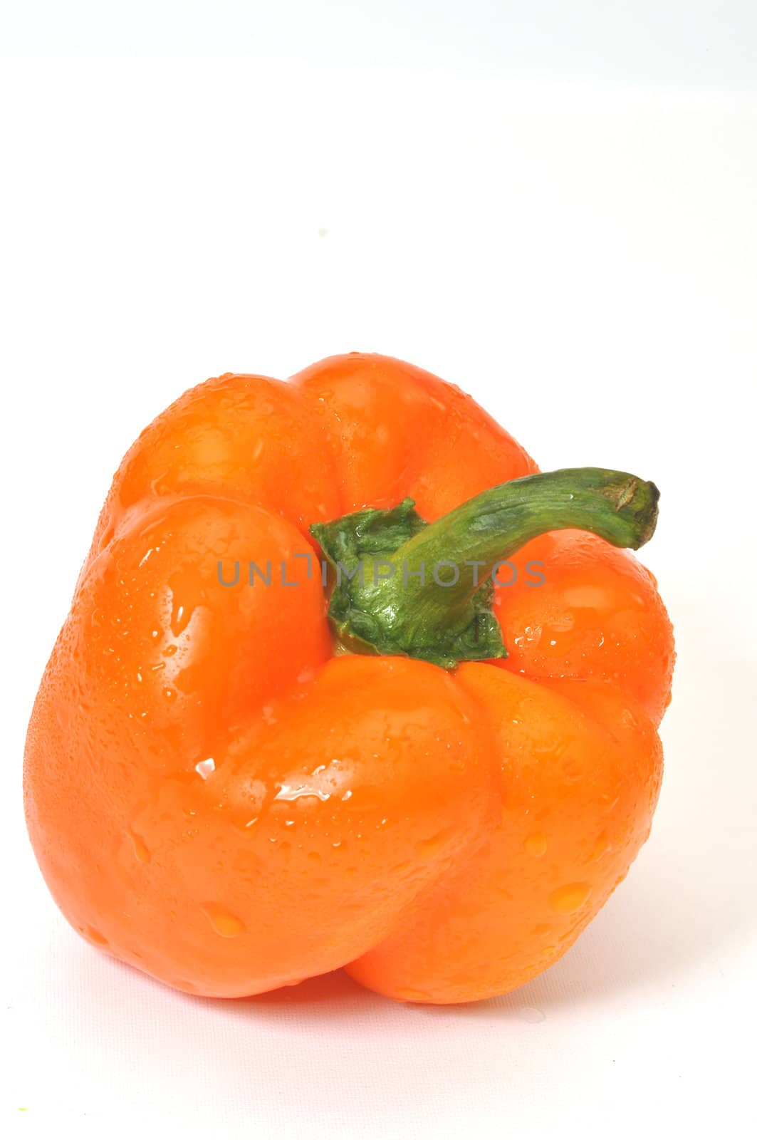 Orange bell pepper isolated on white background.