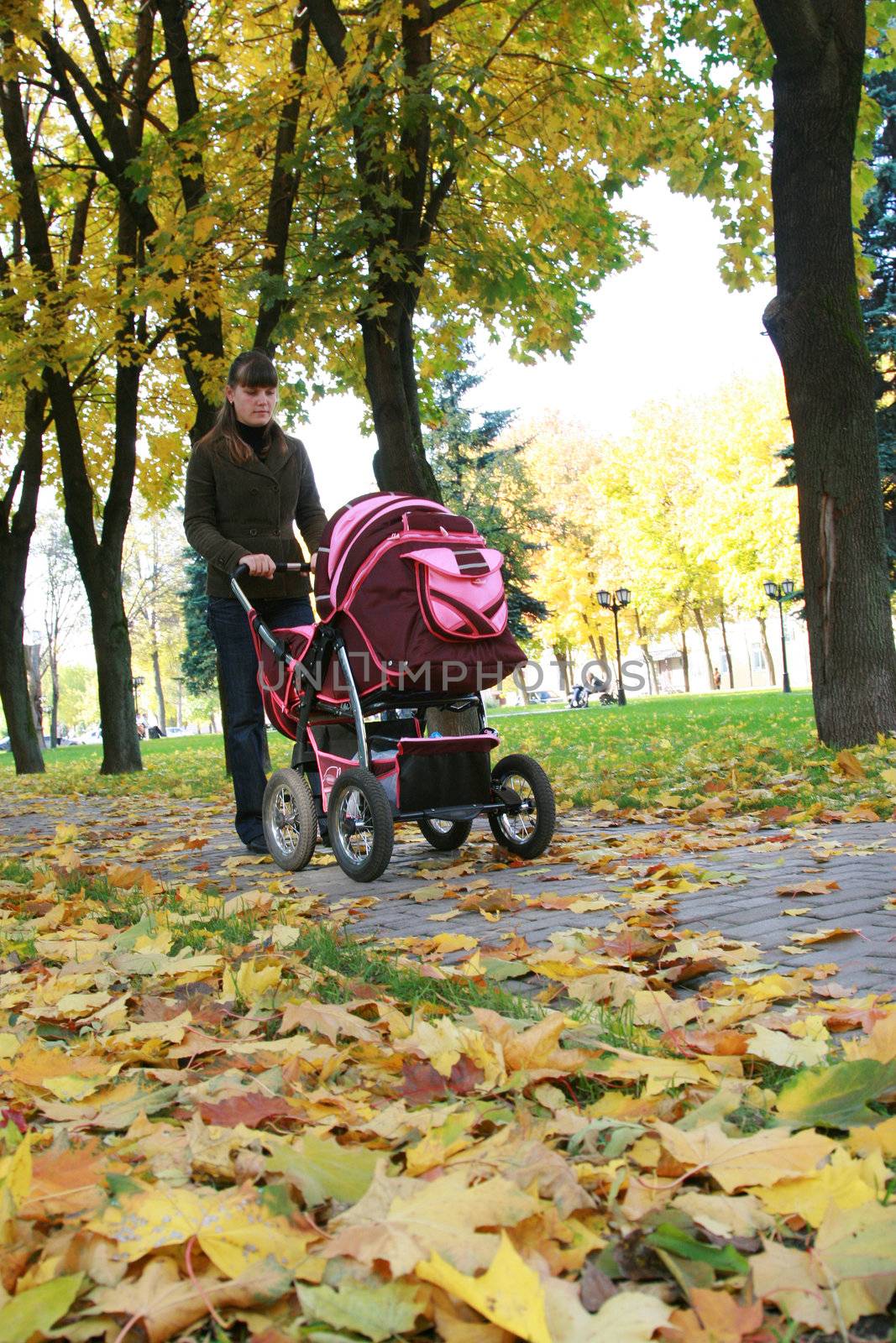 Young mother walks in park with the child
