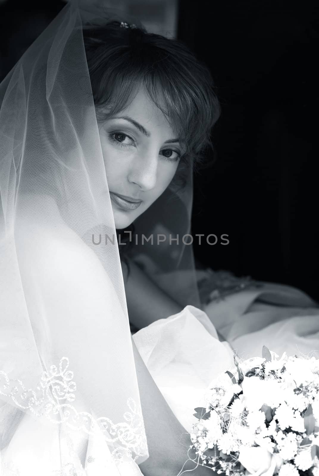 Beautiful the bride with a bouquet in the automobile
