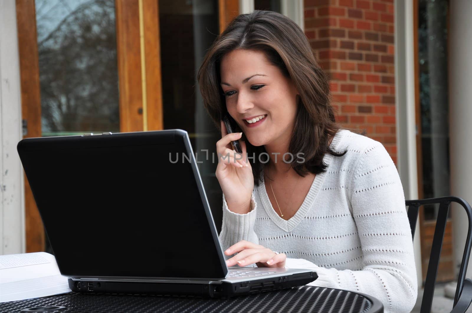 Female Student Using Computer and Cellphone by dehooks