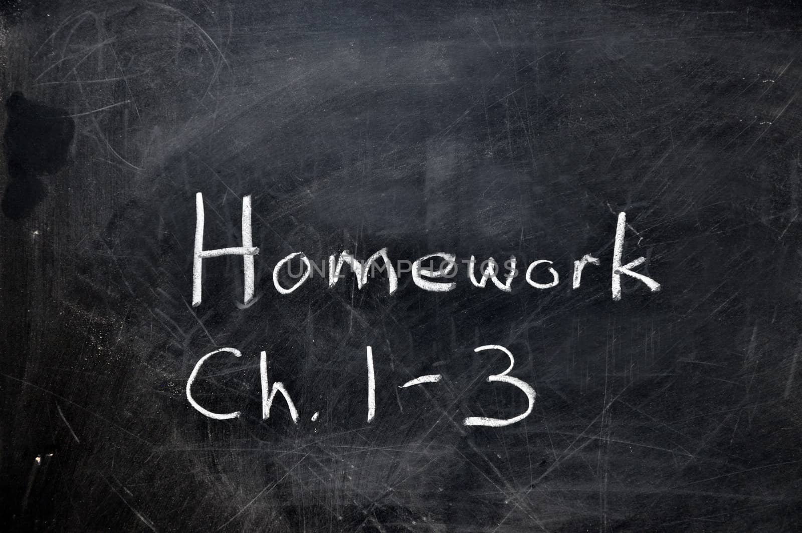 Homework assignment on black chalkboard with copy space.