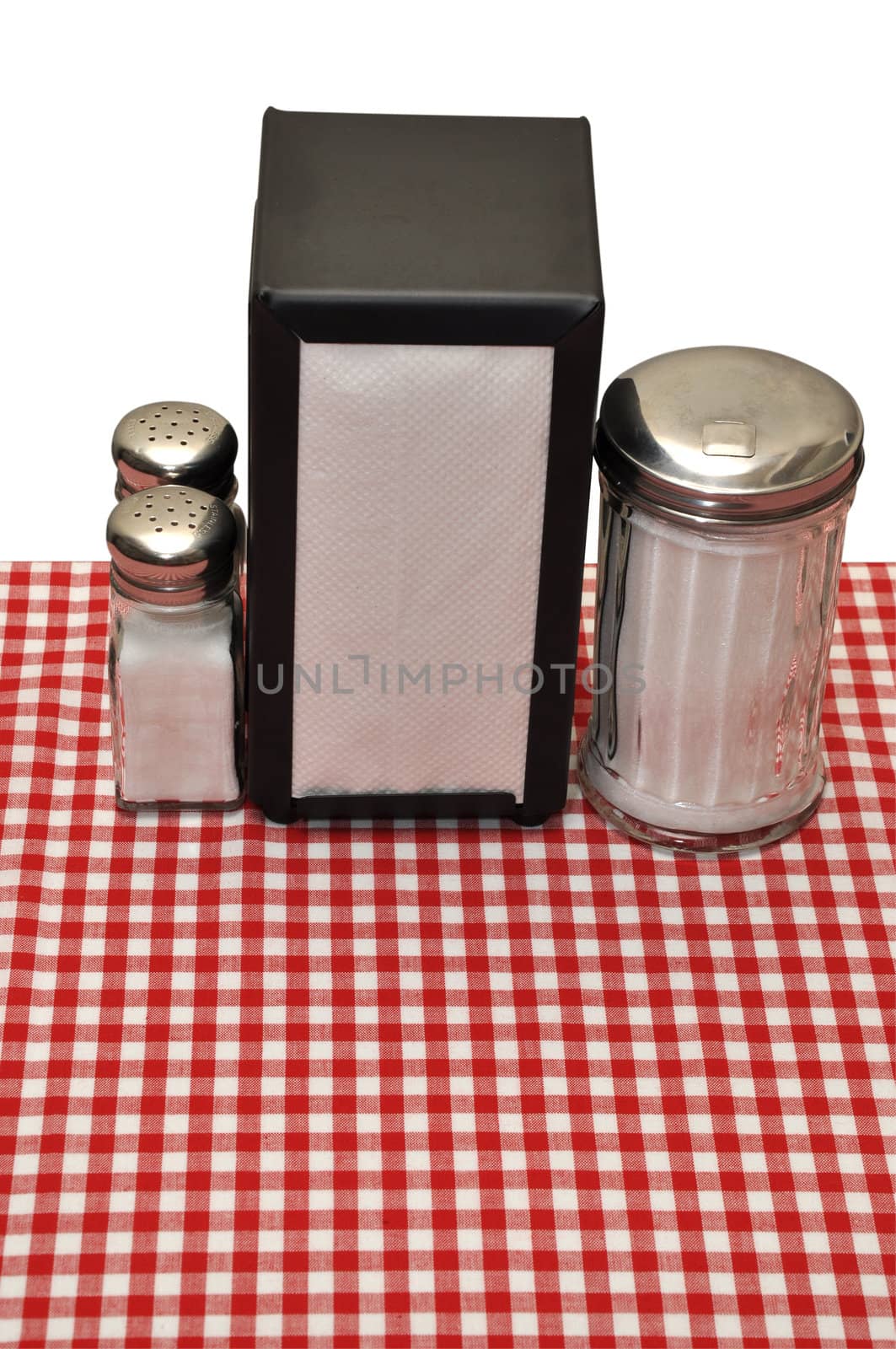 Table with red gingham tablecloth at diner.  Isolated on white background with clipping path.
