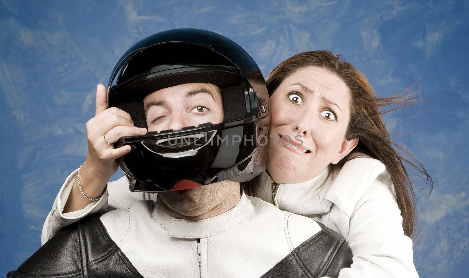Man and fearful woman on a motorcycle in studio