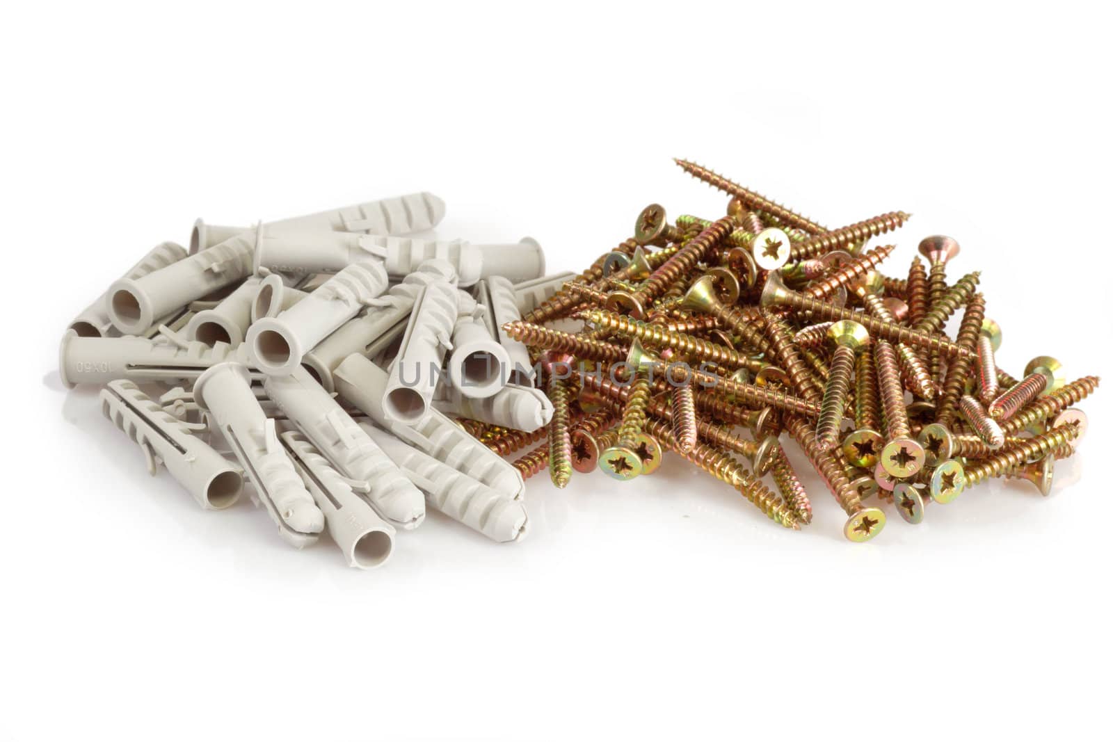 A pile screws and dowels on bright background