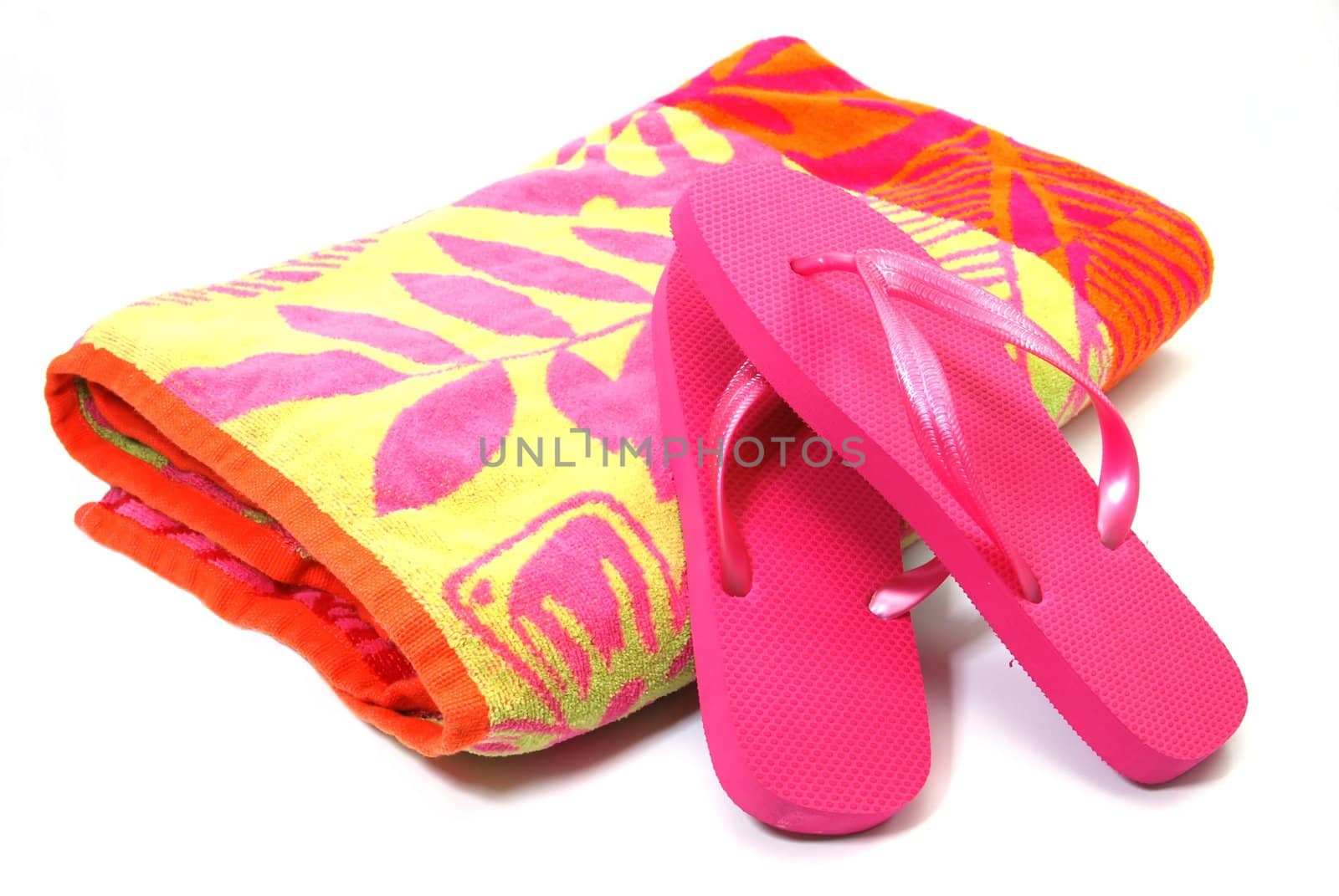 Beach towel and flip flops isolated on white background.