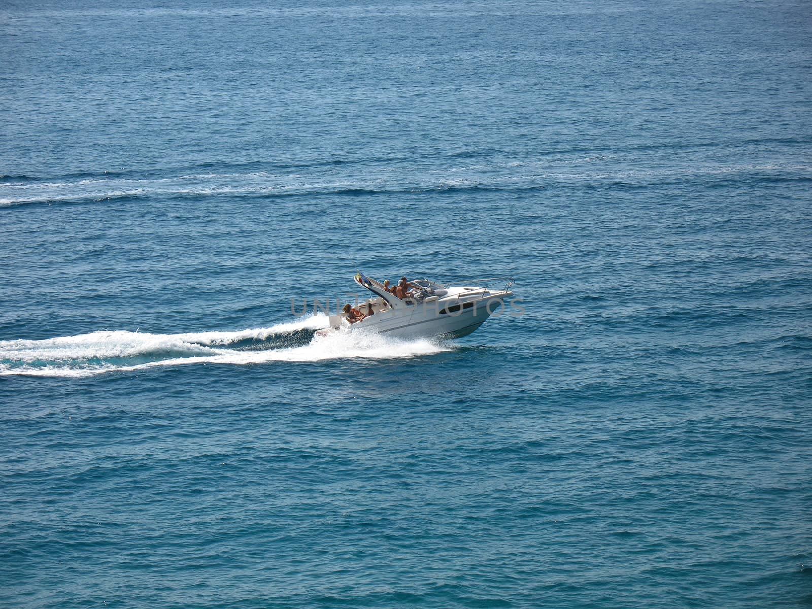 Speed boat on calm blue sea water.