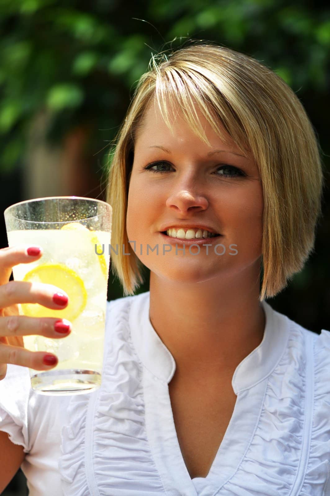 Blond woman with glass of lemonade.  