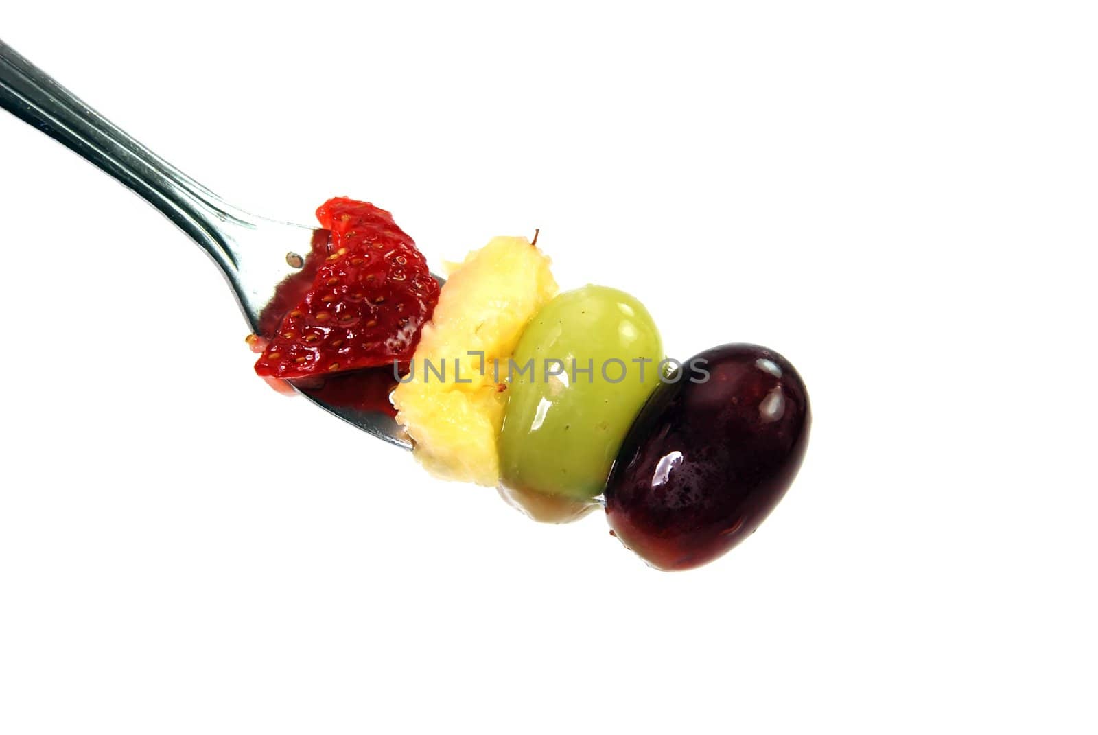 Fruit on fork isolated on white background with clipping path.