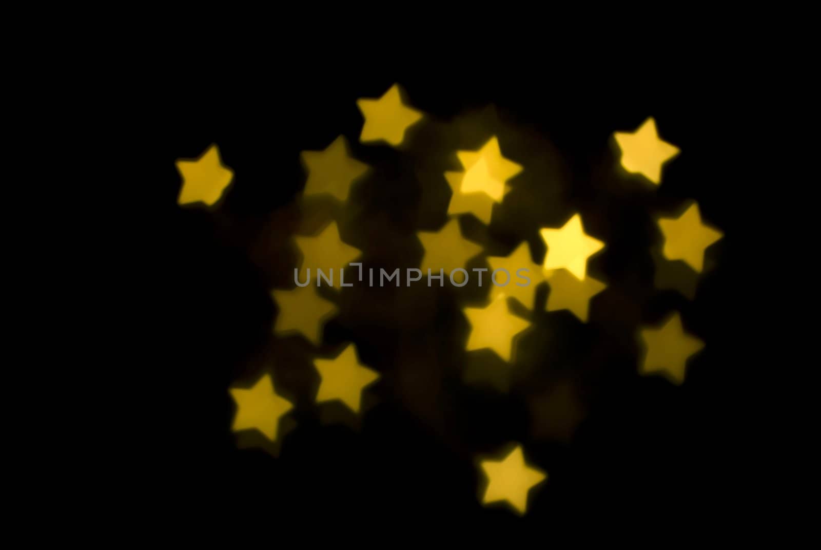 a background image of yellow gold bokeh stars