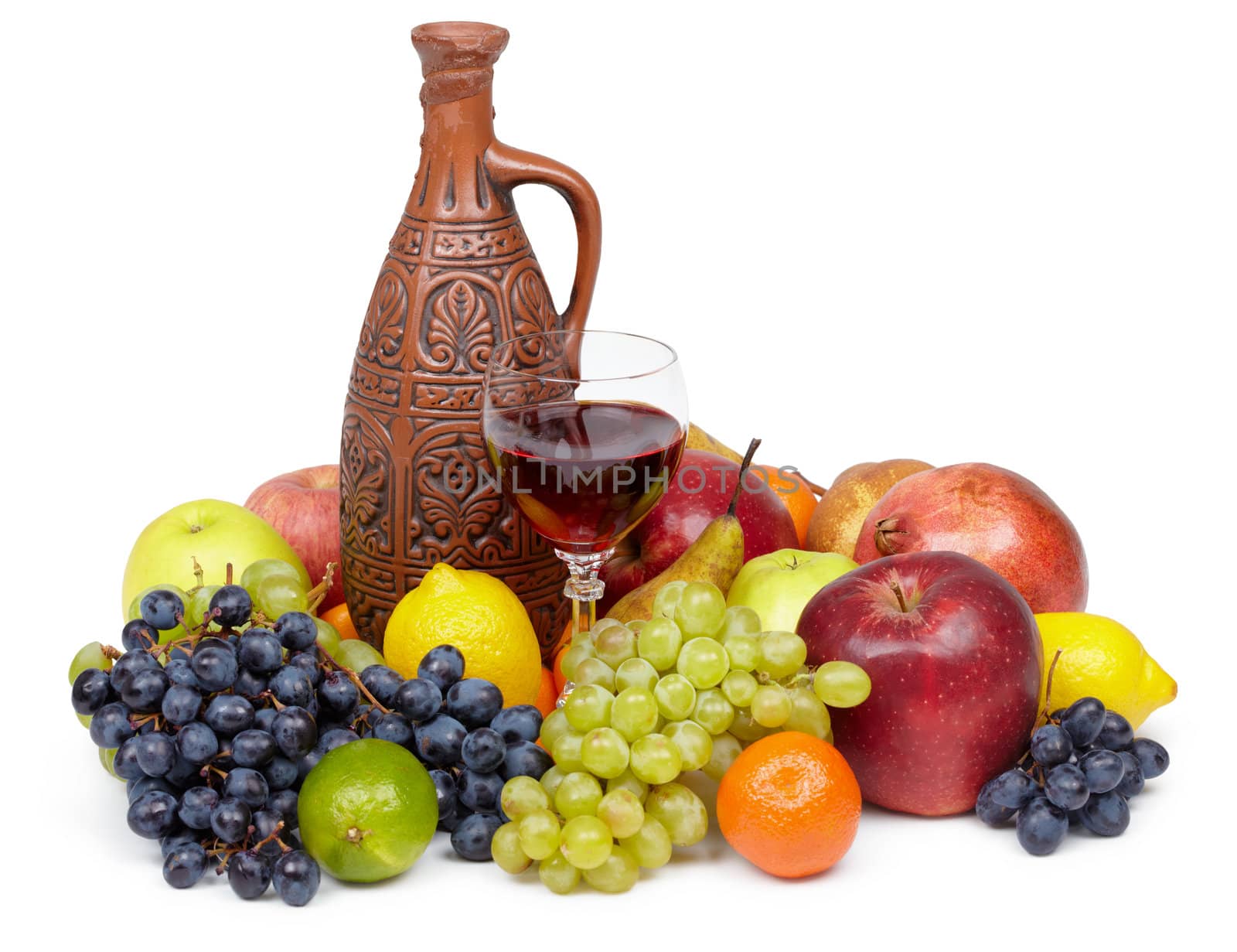Artistic composition of fruit and jug of wine on white