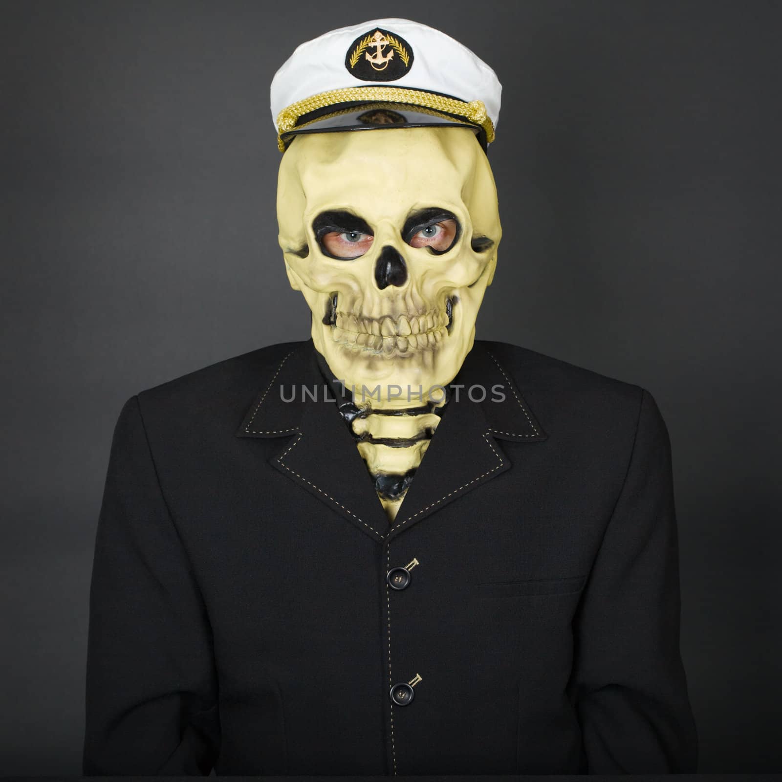 The man - a skeleton in a naval cap on a dark background