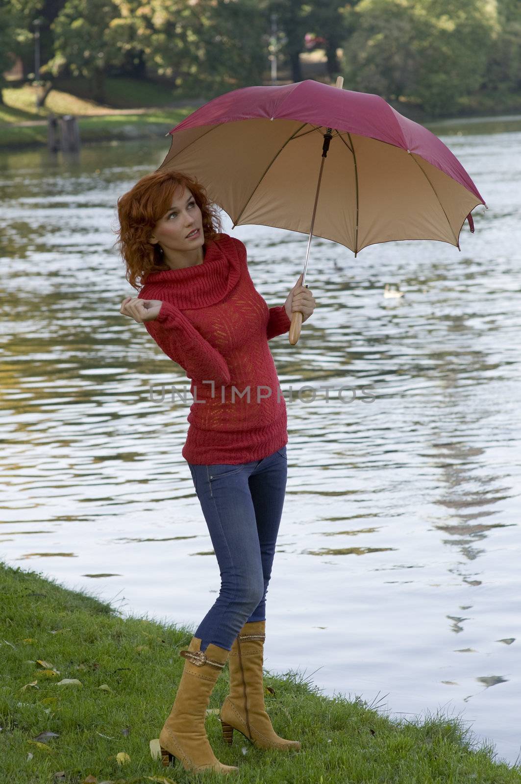 beautiful woman with umbrella looking up the sky if stop raining