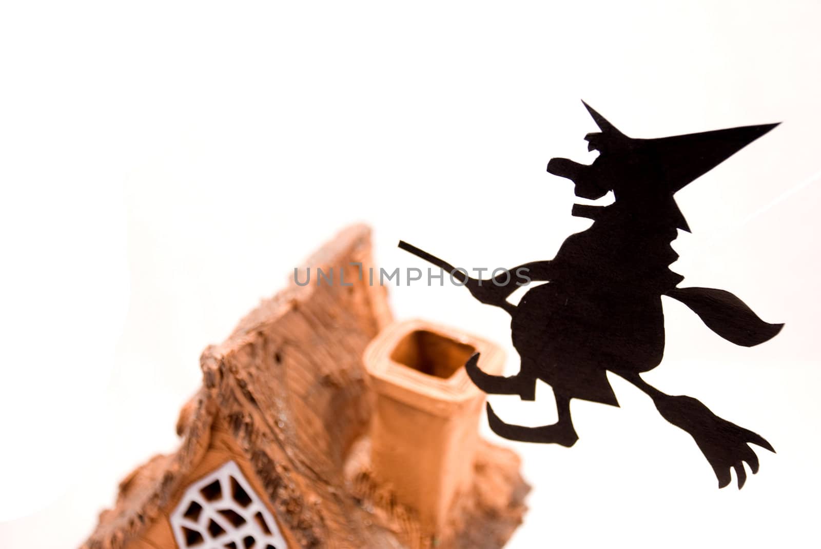 Witch,flying on broom on house,on white background
