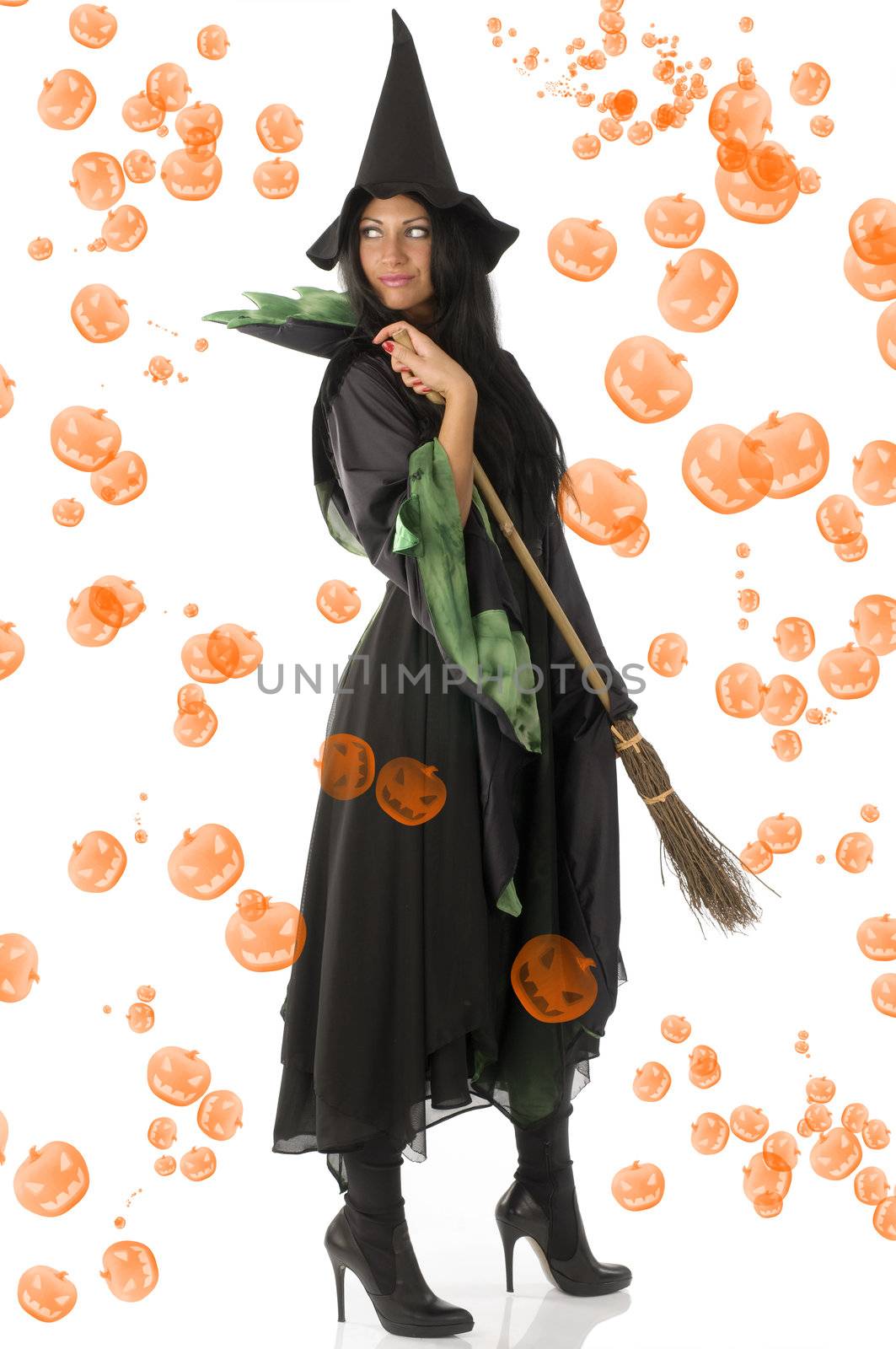 cute brunette in green and black witch dress with broom and hat isolated on white