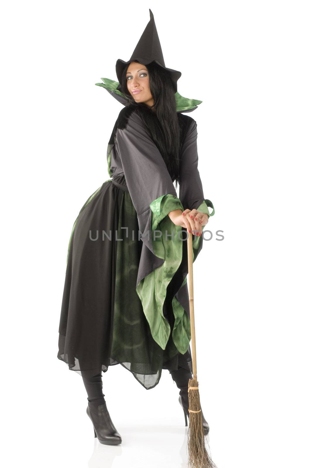 witch in green and black witch dress with broom and hat posing