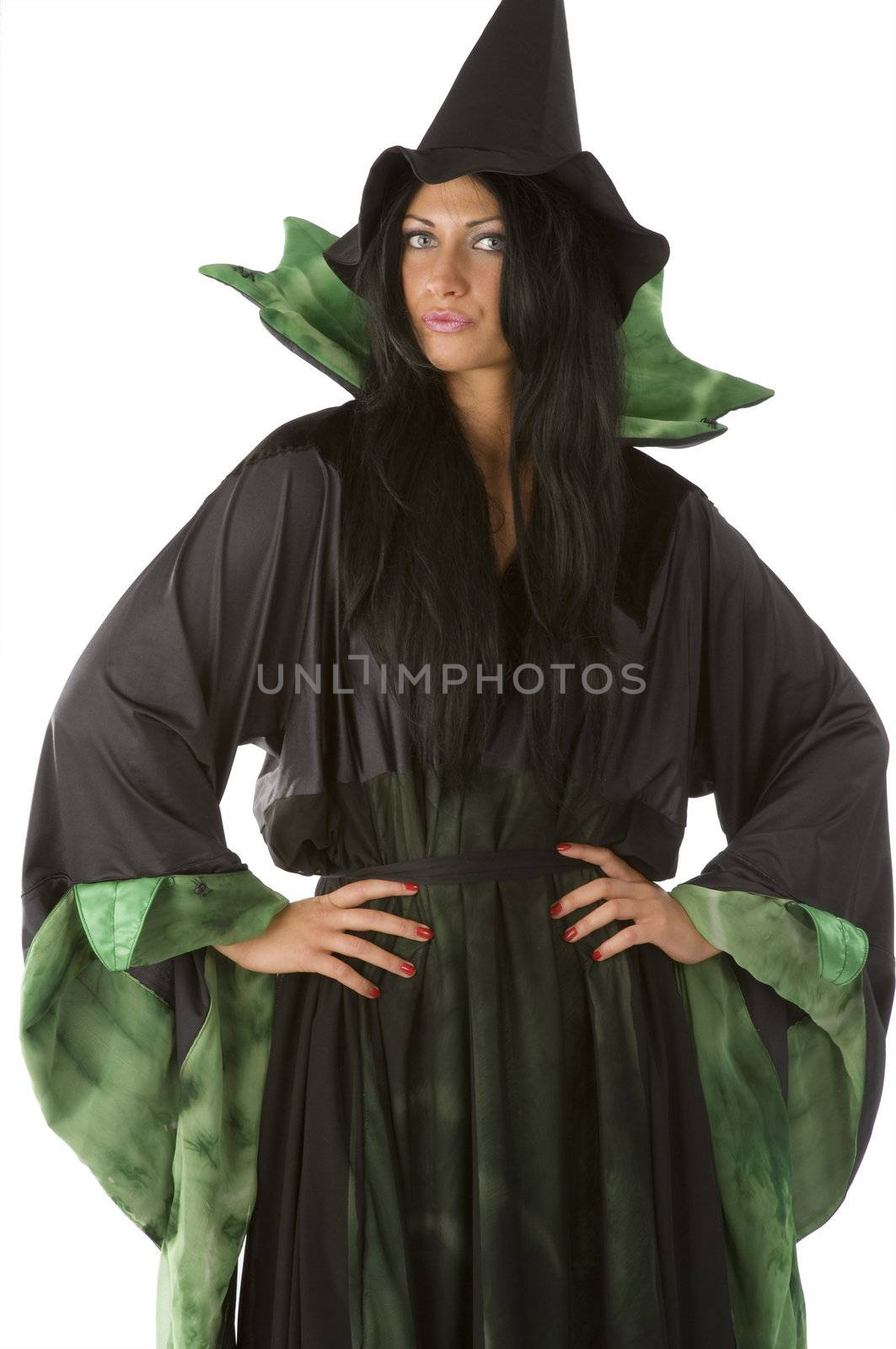 beautiful witch in pose with a black and green dress and hat