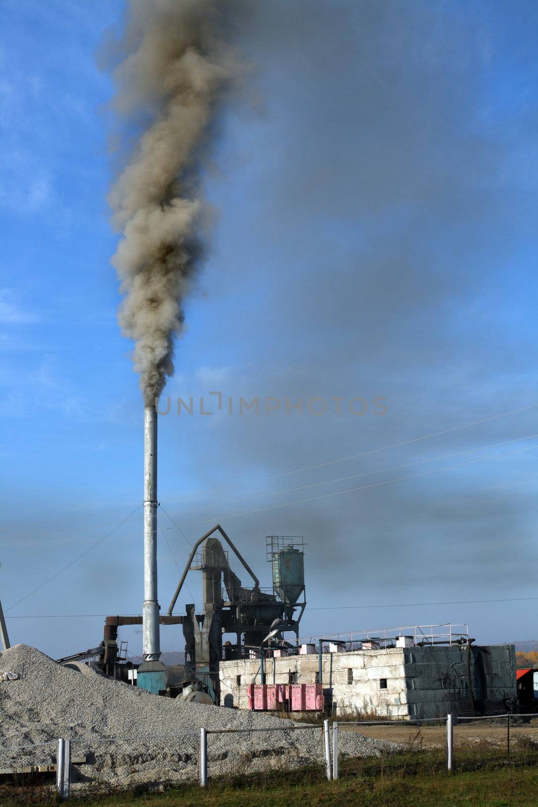 environment pollution - black toxic smoke in blue sky