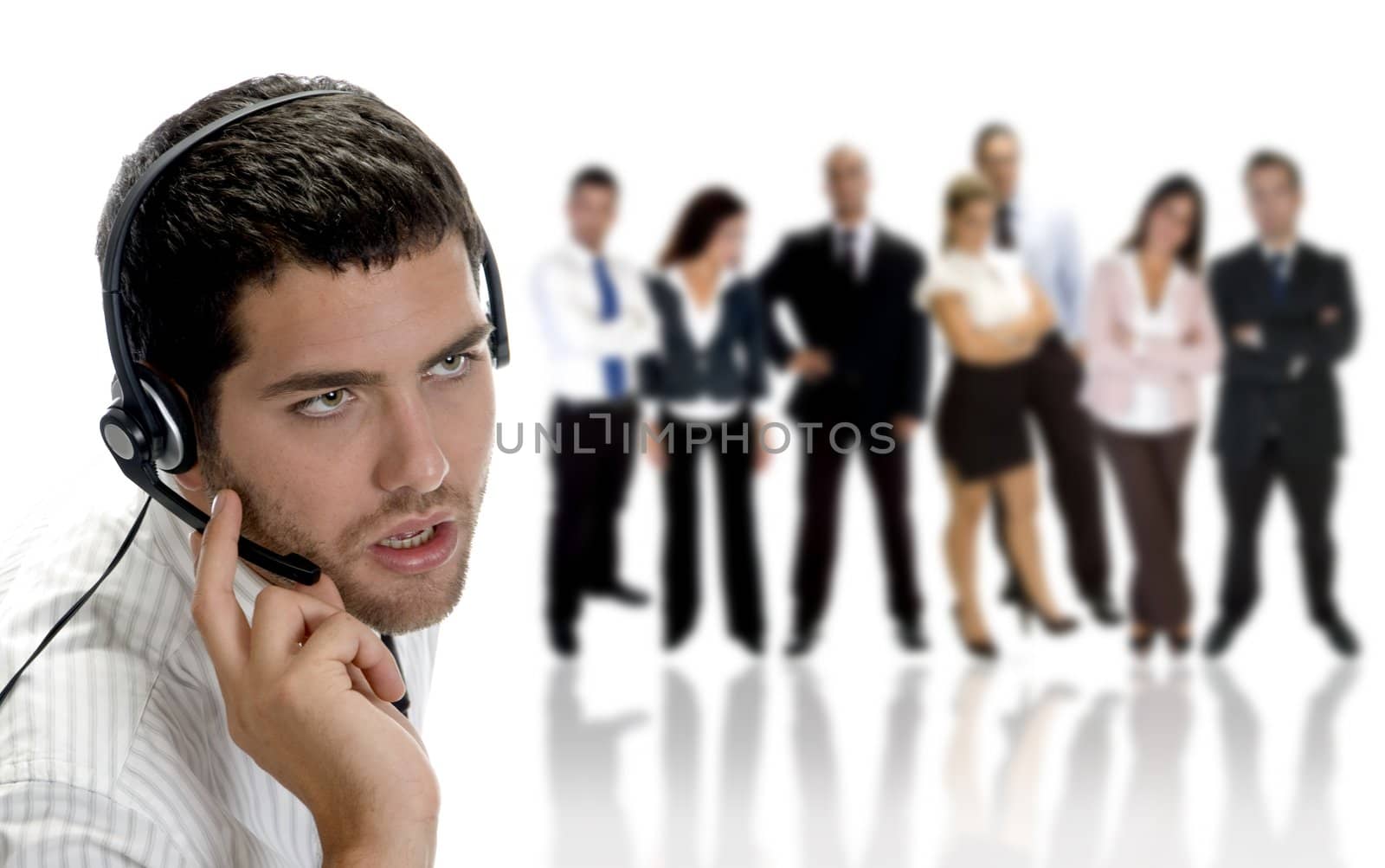 businessman talking on headphone with businesspeople