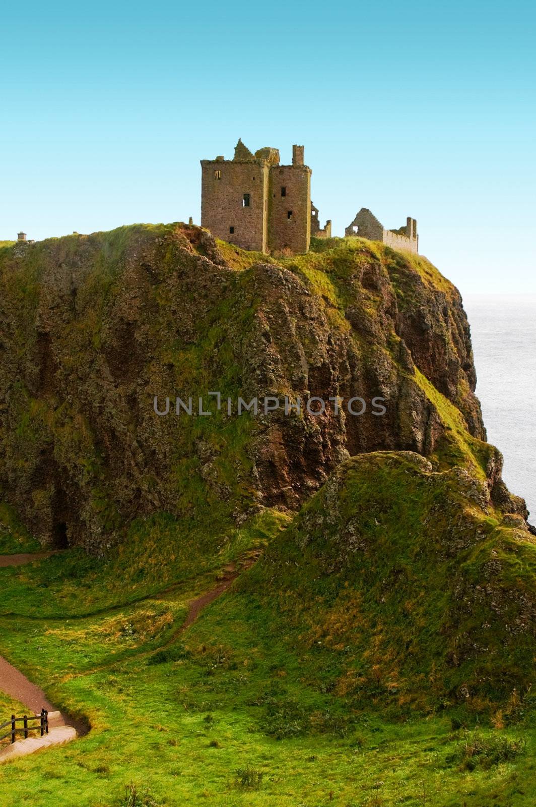 dunnottar castle on a cliff vovered with grass