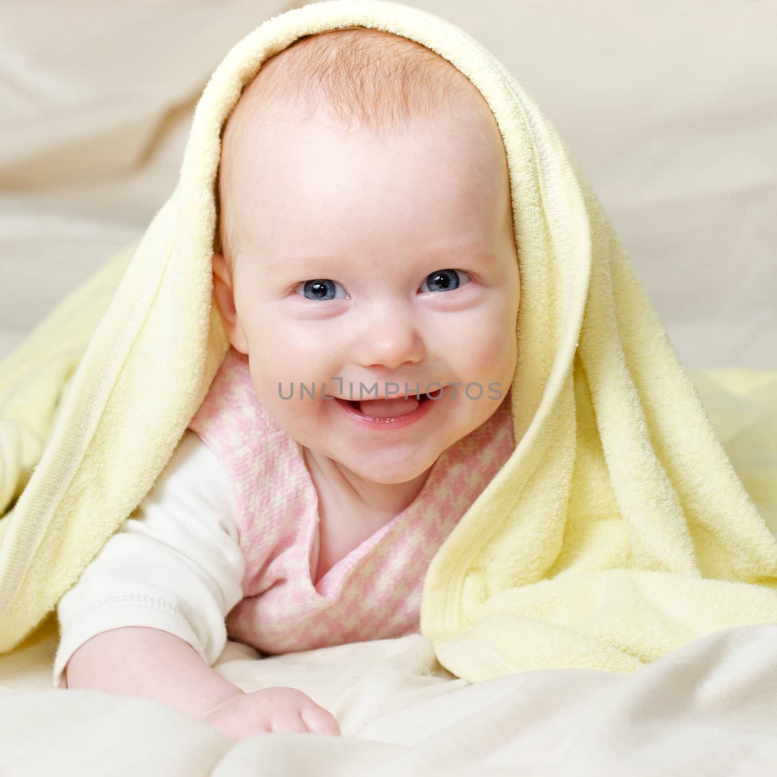 Portrait of cheerful four month baby girl with blue eyes and red hair