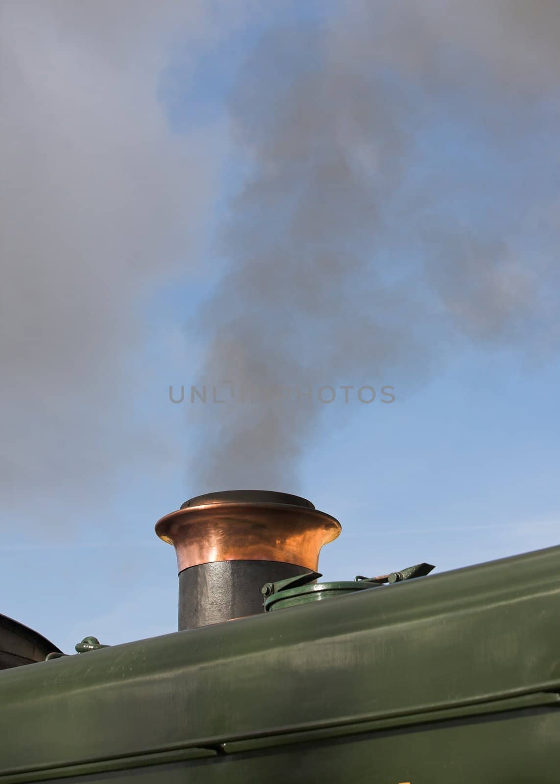 Smoke rising from the funnel of a restored steam engine