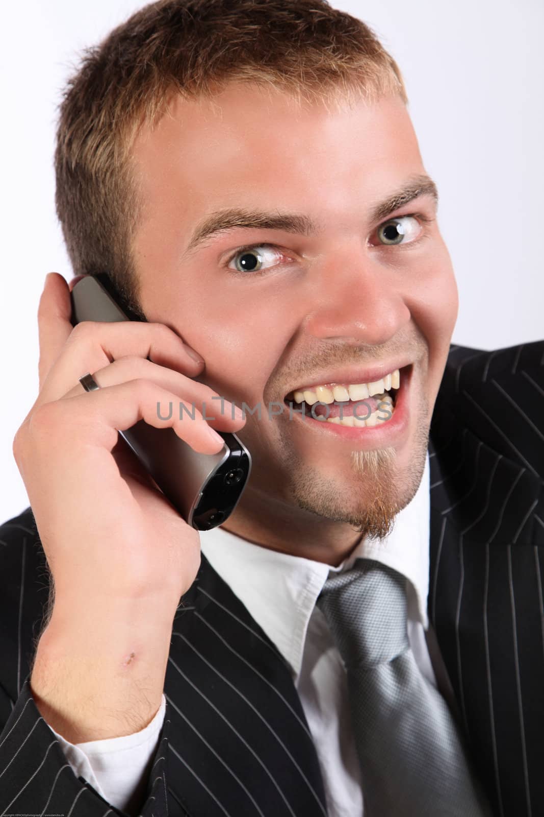 Portrait Of A Corporate Young Man Being Enthusiastic On Telephone