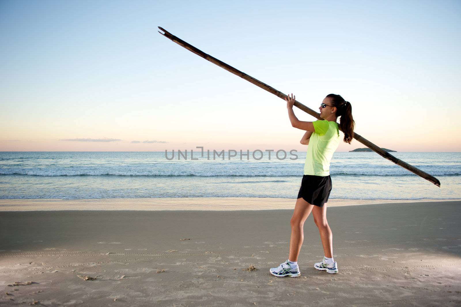 Woman doing exercises during sunset with sunglasses in Florianopolis, Santa Catarina, Brazil, Nikon D3S, Nikon 24-70mm, RAW shooting.