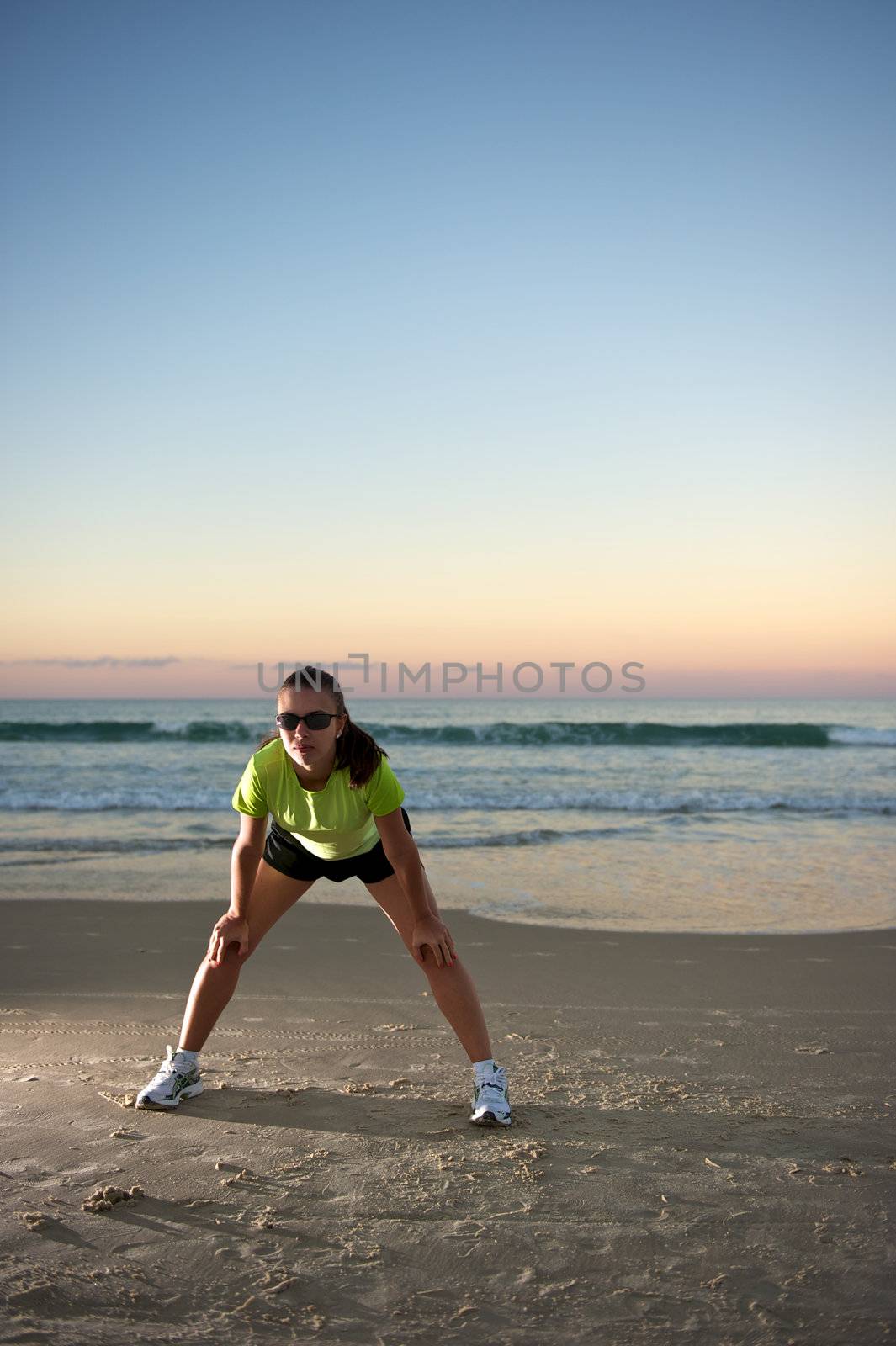 Woman doing exercises during sunset with sunglasses in Florianopolis, Santa Catarina, Brazil, Nikon D3S, Nikon 24-70mm, RAW shooting.