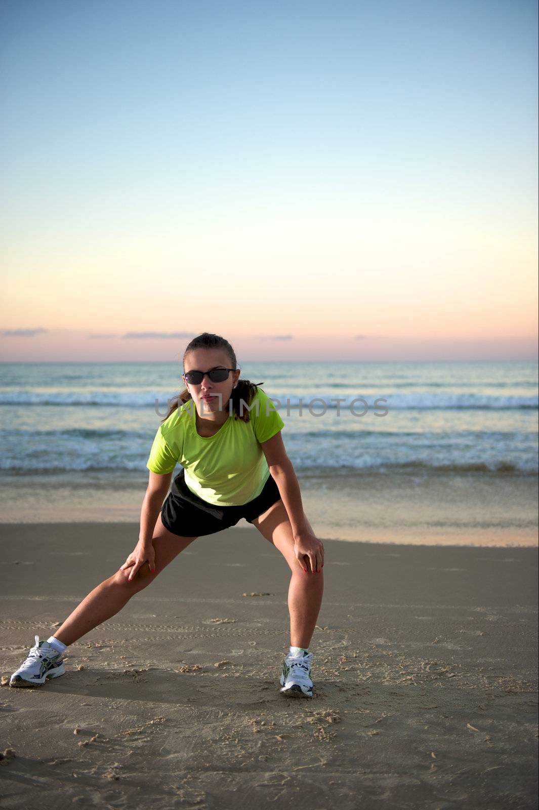 Woman doing exercises during sunset with sunglasses in Florianopolis, Santa Catarina, Brazil, Nikon D3S, Nikon 24-70mm, RAW shooting.