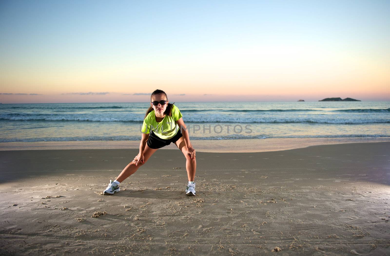 Woman doing exercises during sunset with sunglasses in Florianopolis, Santa Catarina, Brazil, Nikon D3S, Nikon 24-70mm, RAW shooting.