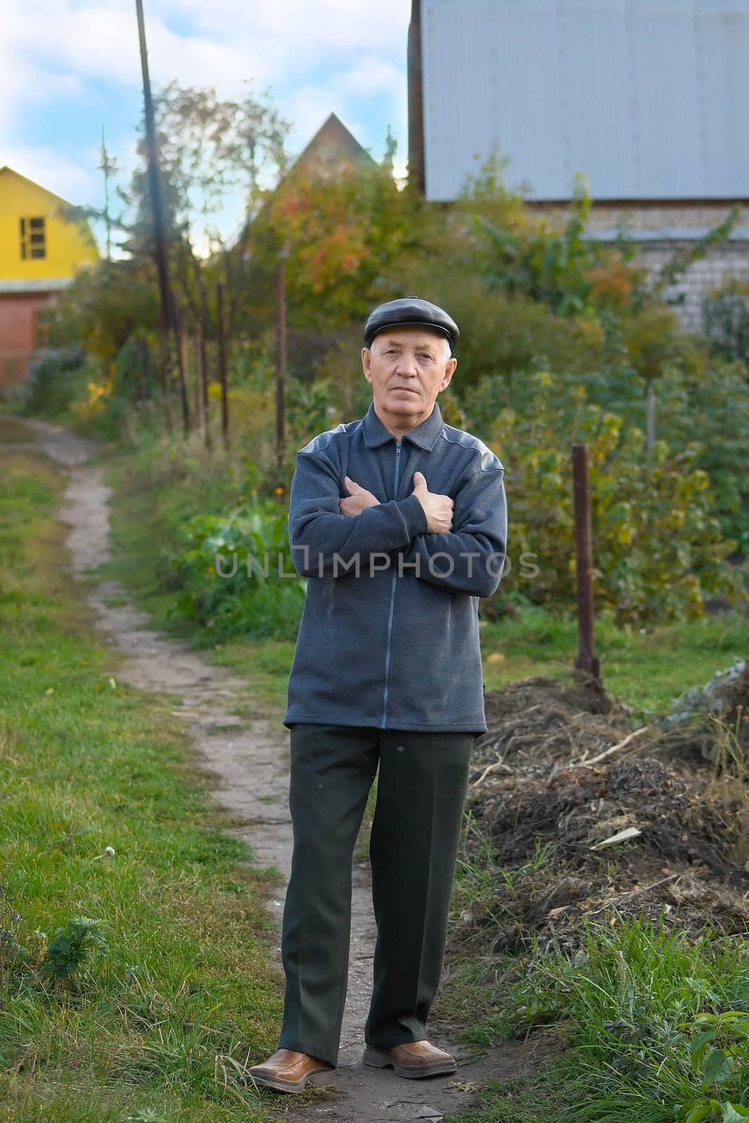 the elderly man in a cap against the nature