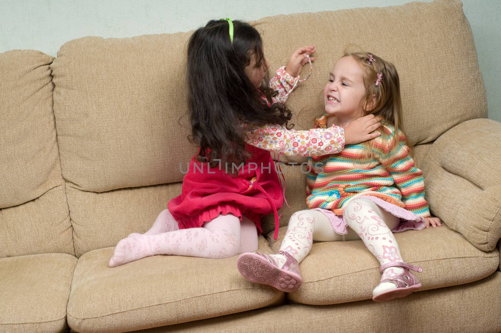 two little girls conflicting and trying to fight