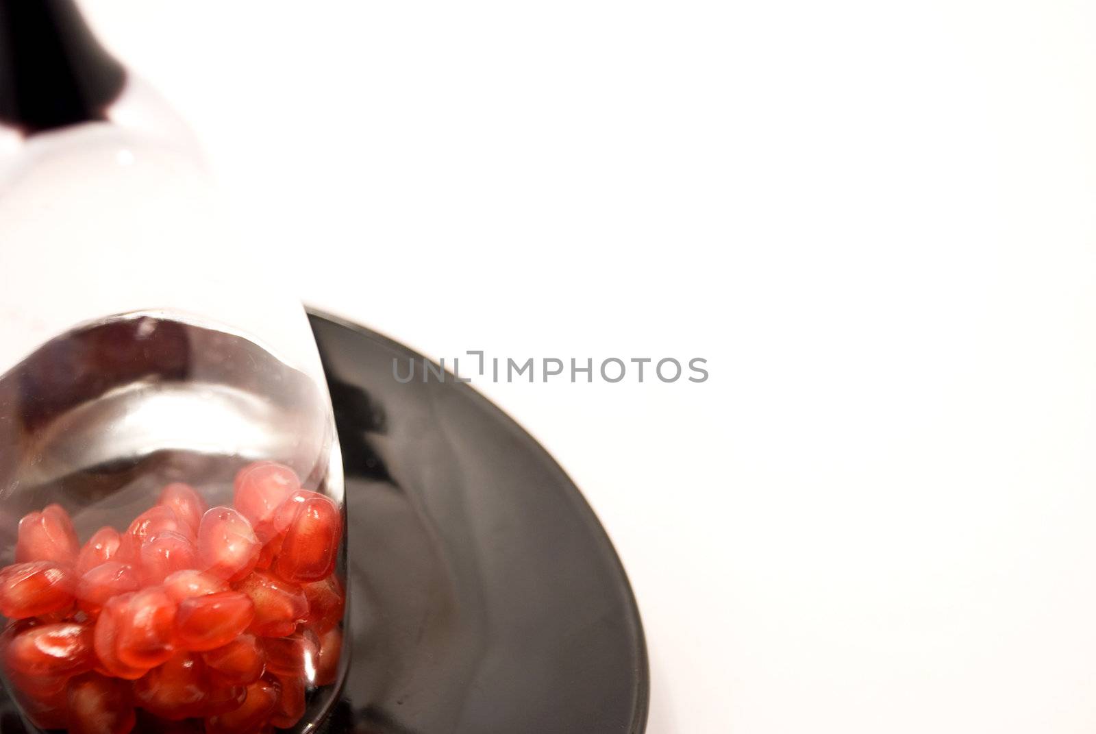 Seeds grenade on a plate inside the wineglass by jannyjus