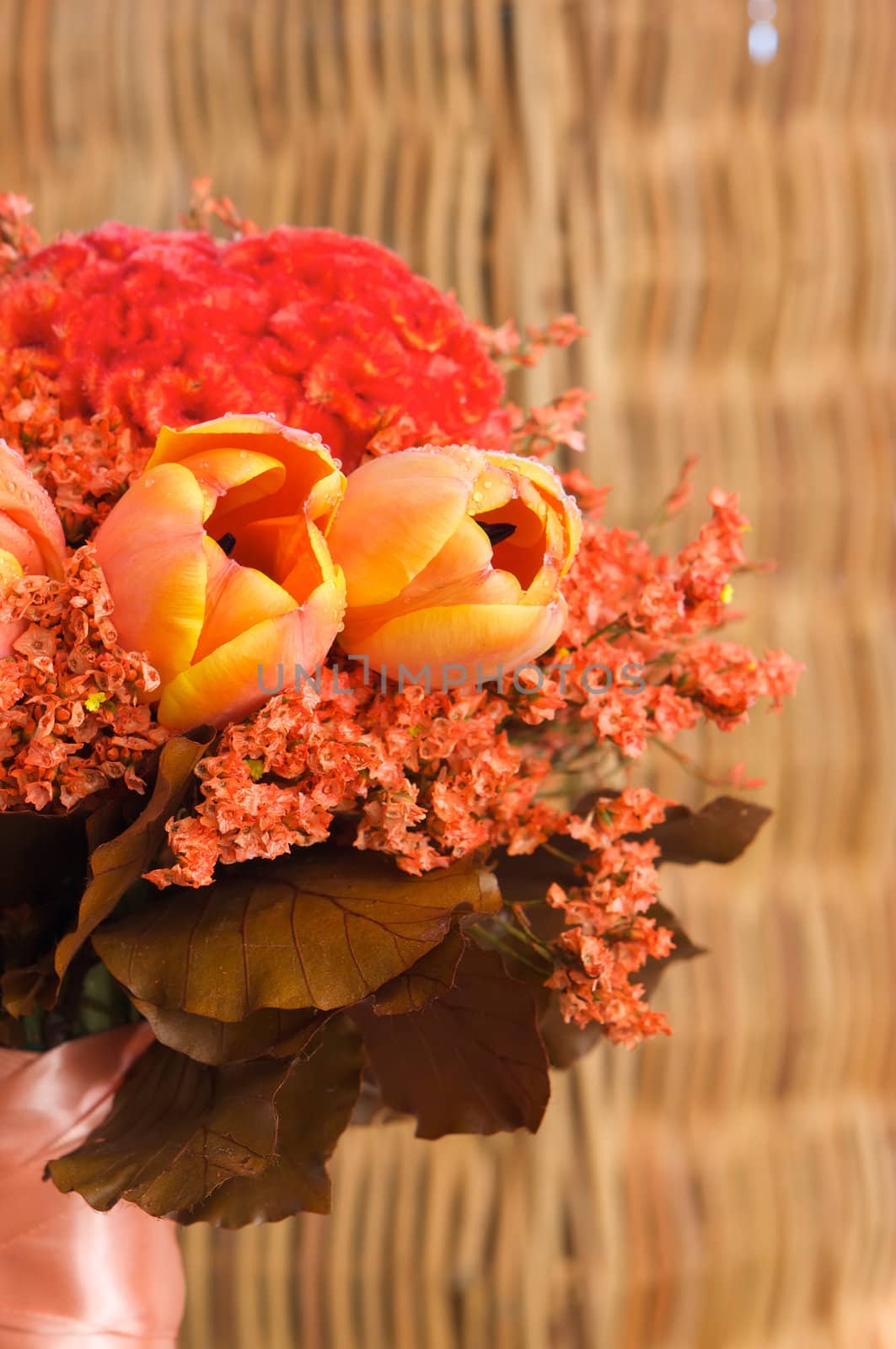 A colorful red and orange bridal bouquet of flowers