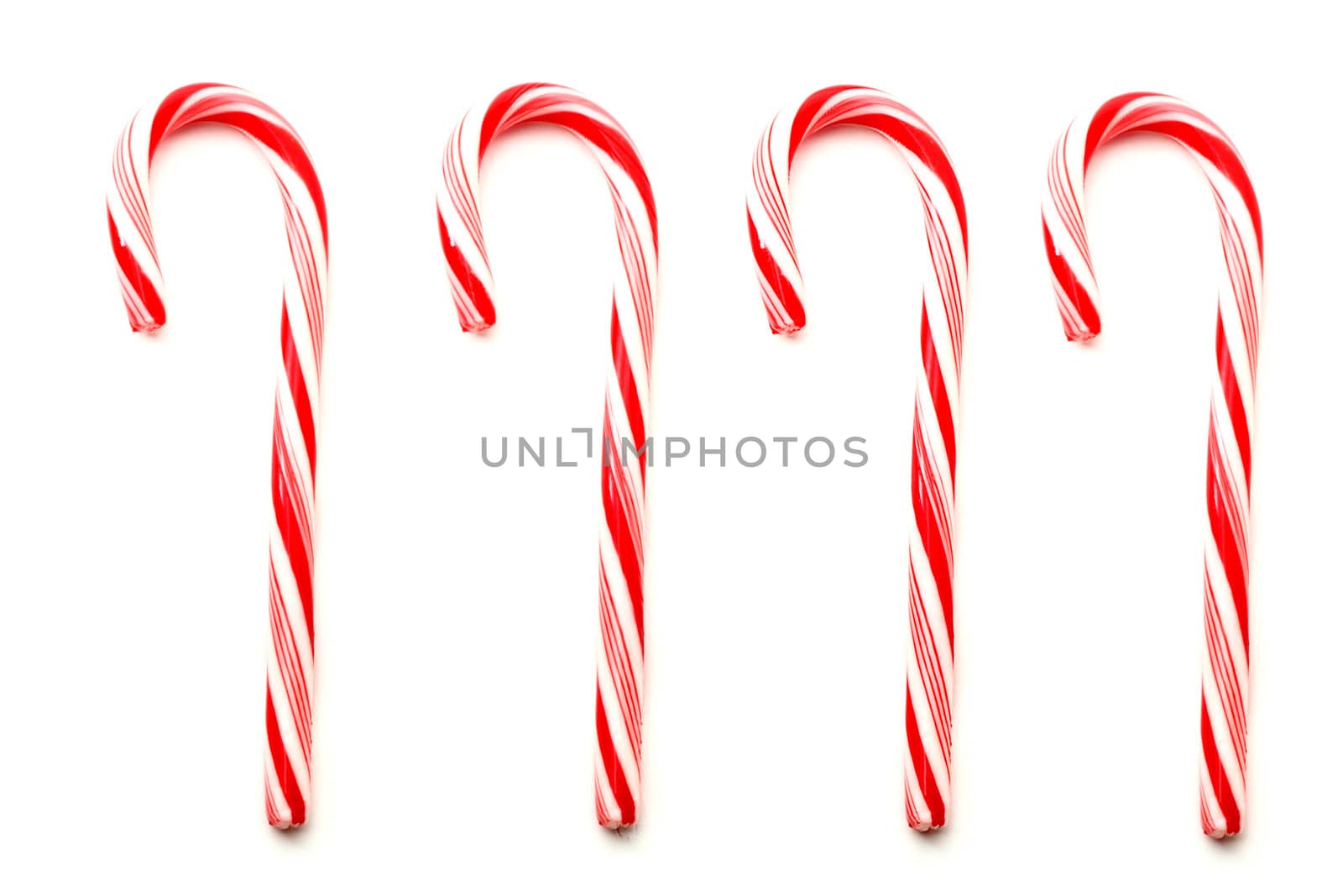 Four red and white Christmas candy canes isolated on white