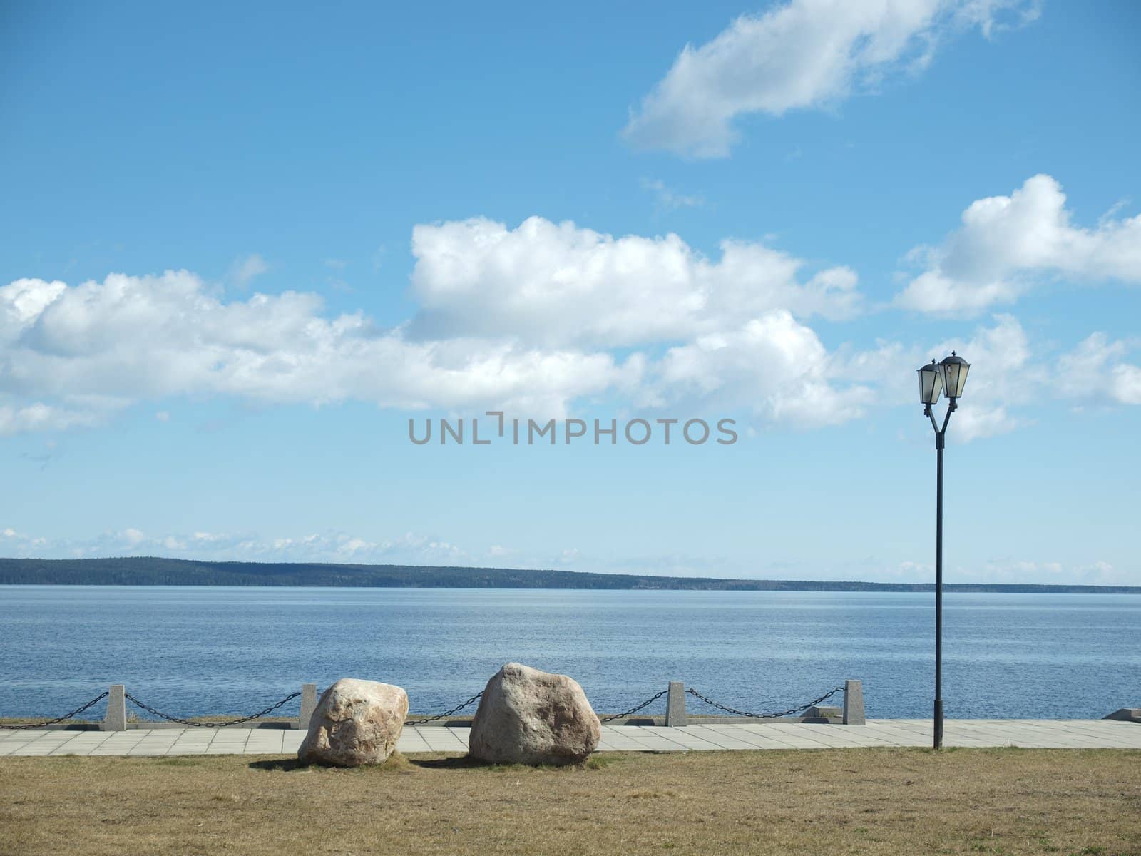 Stones and lantern on coast of the Onega lake