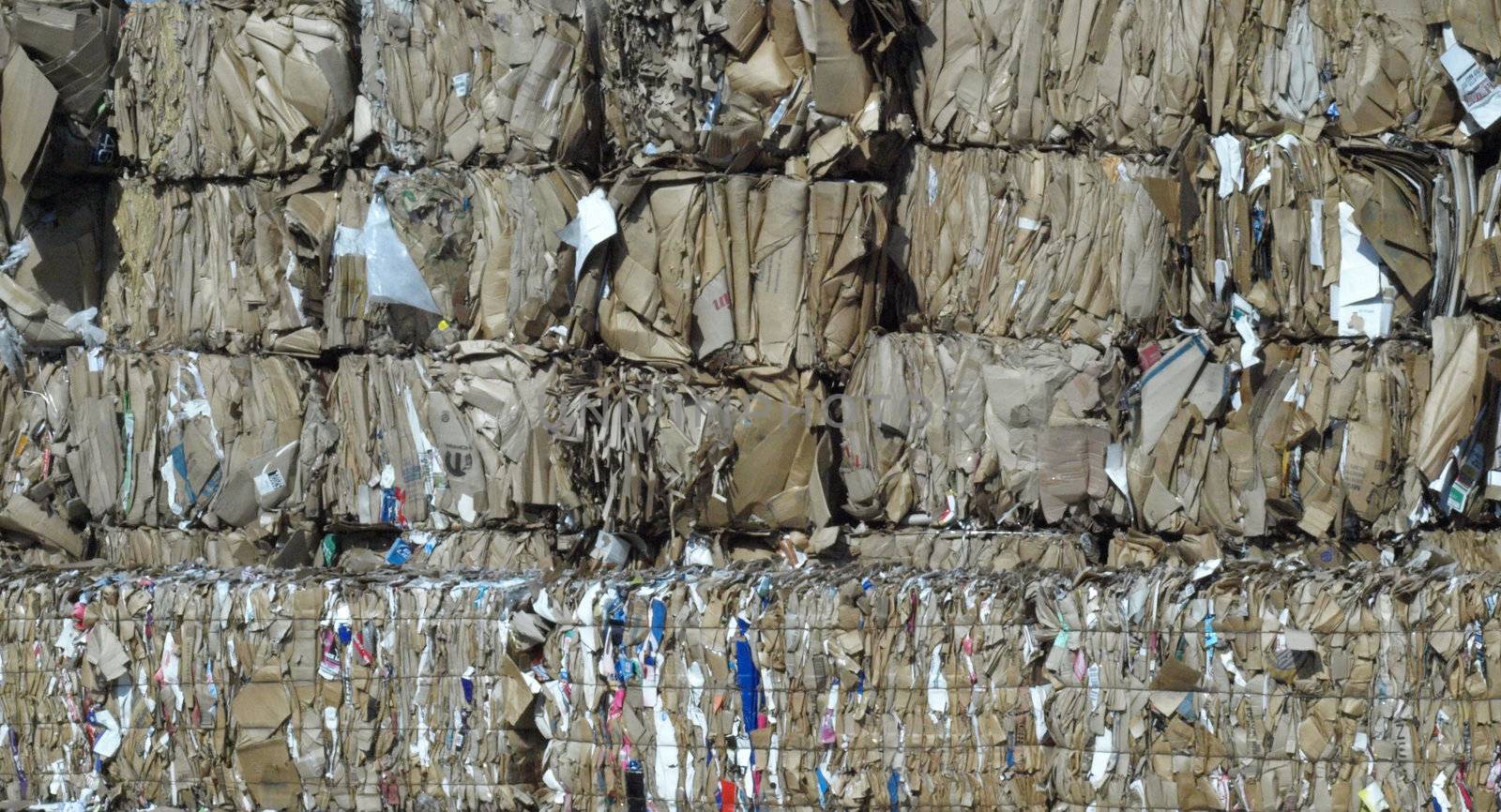 Stacks of brown cardboard boxes crushed and ready for recycling