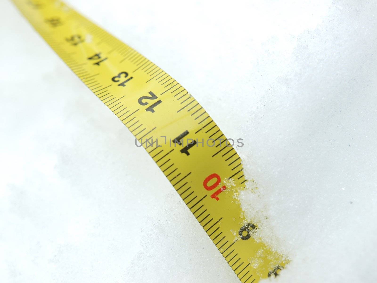 Measuring tape on a snow in the winter        