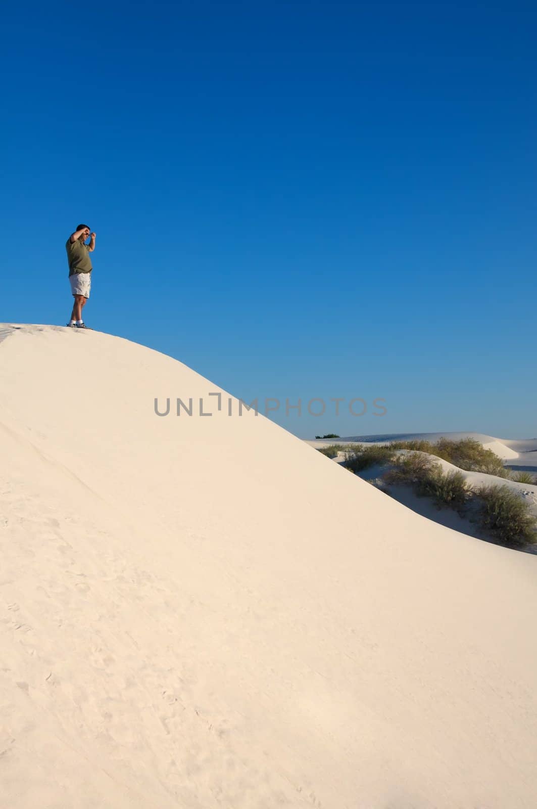 A man exploring in the desert by Deimages