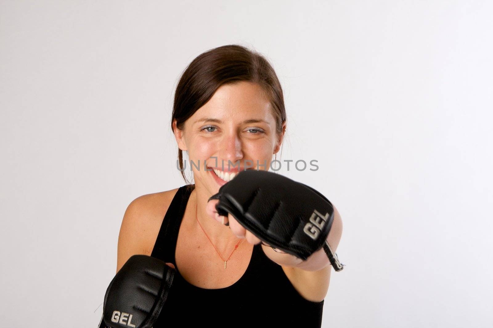 An image of a woman in gym clothes, with boxing gloves, strength and fitness