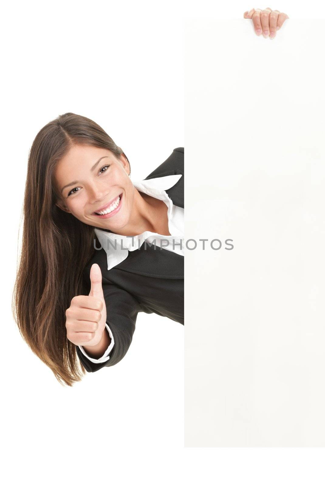 Advertisement woman holding sign. Businesswoman in suit giving the thumbs up success sign while showing a blank white billboard sign. Mixed race Chinese Asian / Caucasian woman isolated on white background. 