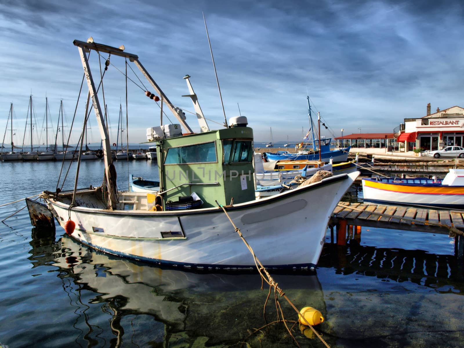 image of a fisher boat in a little provence harbor