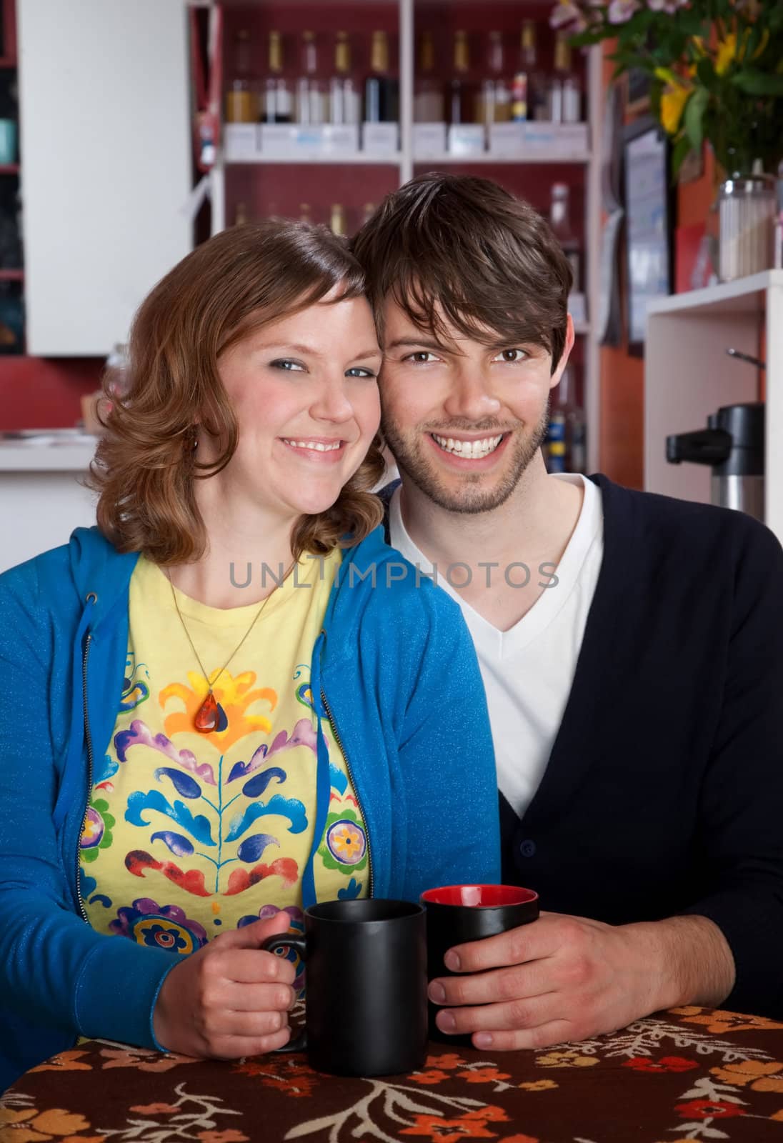 Smiling couple sitting together in a cafe