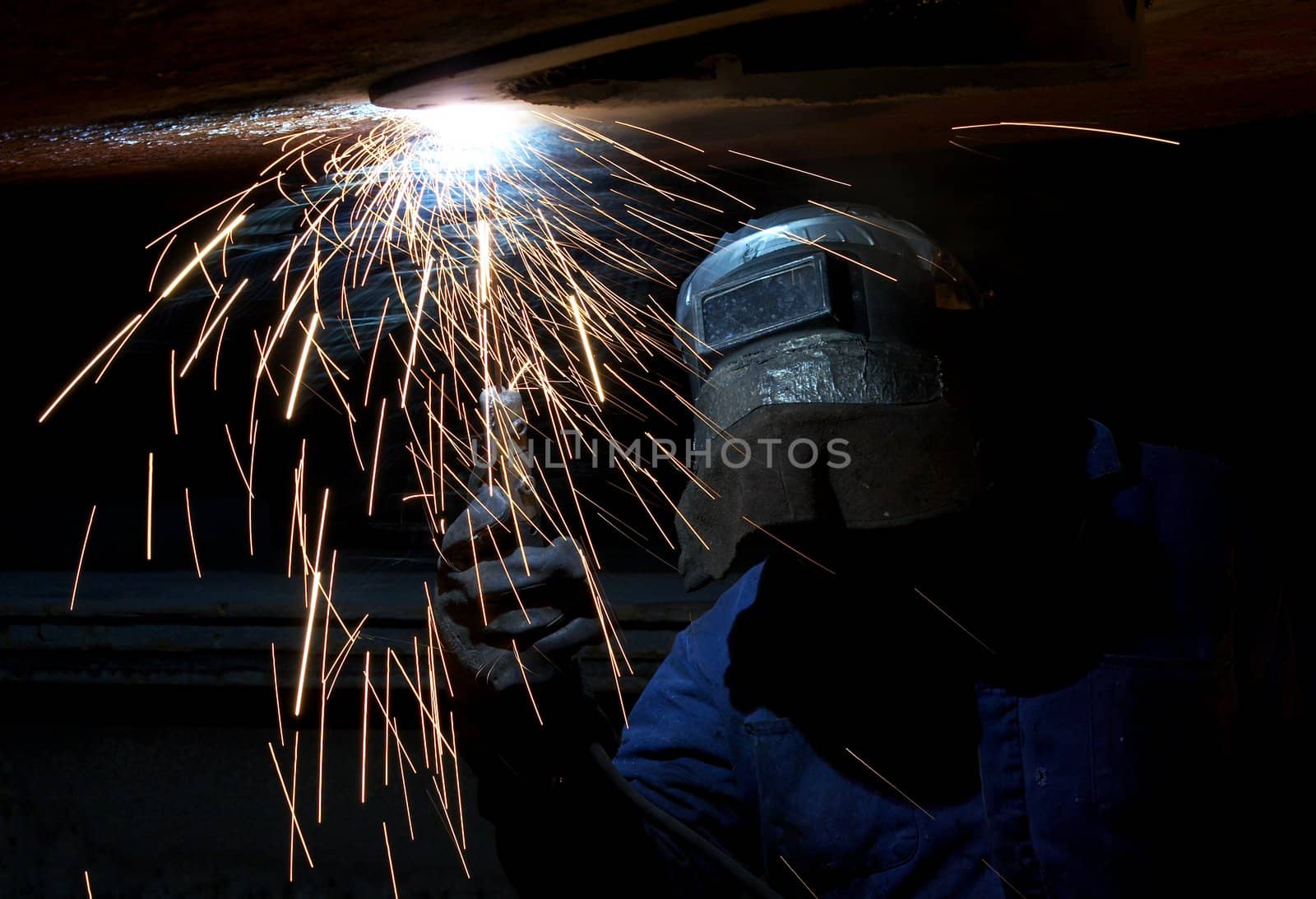 a welder working at shipyard at night